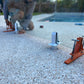 GlassMate tool supports the glass and then can be easily adjusted to ensure the glass is level, plumb and perfectly aligned with other panels before setting spigots into concrete