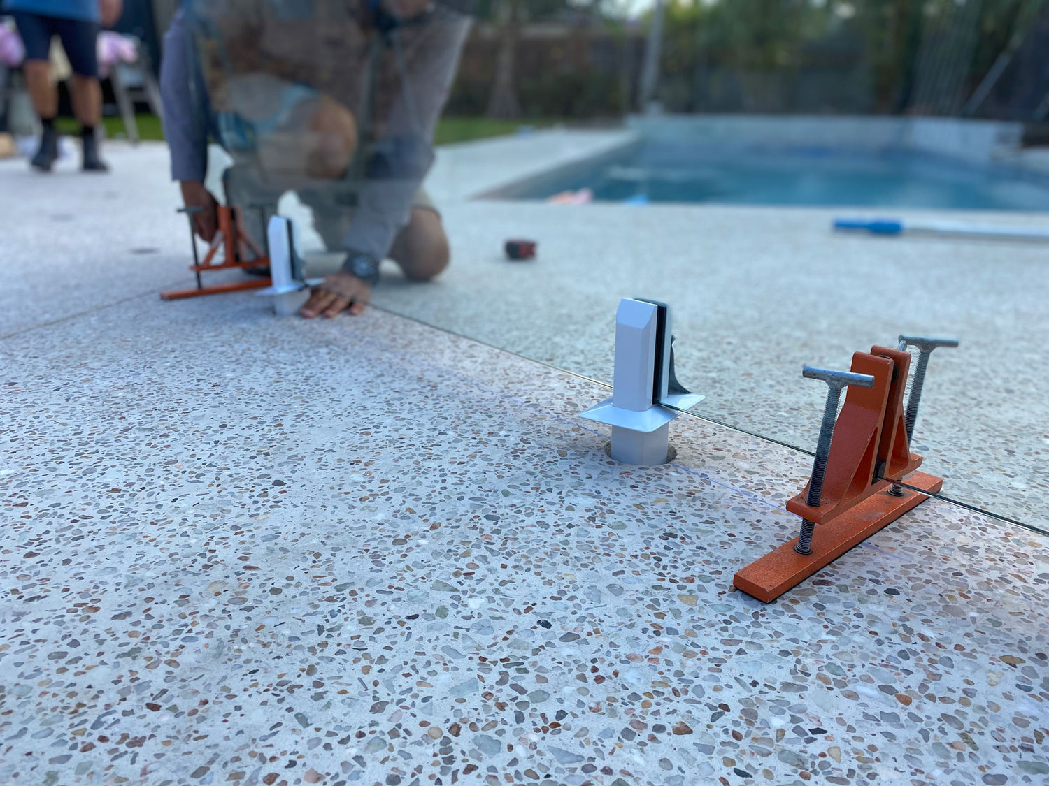 GlassMate tool supports the glass and then can be easily adjusted to ensure the glass is level, plumb and perfectly aligned with other panels before setting spigots into concrete